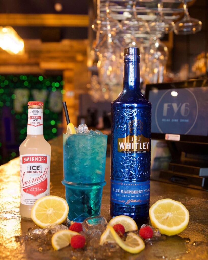 Blue cocktail and bottles on the bar at FY6